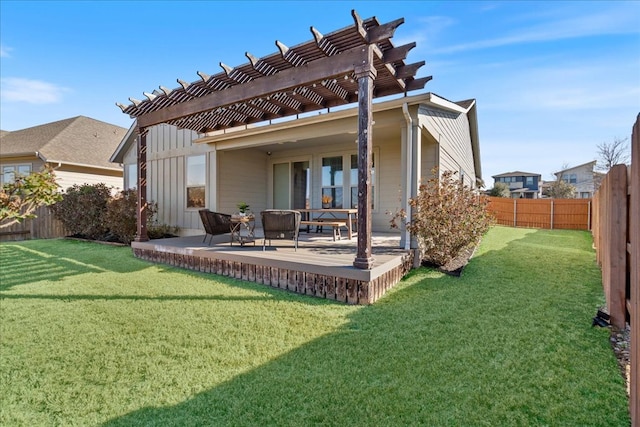 rear view of house featuring board and batten siding, a patio, a fenced backyard, and a pergola