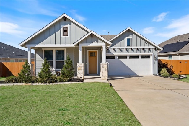 craftsman inspired home featuring board and batten siding, a front lawn, fence, driveway, and an attached garage