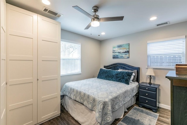 bedroom featuring baseboards, dark wood-style flooring, visible vents, and recessed lighting