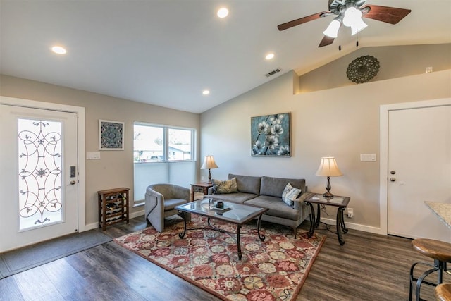 living area with baseboards, dark wood-style floors, a ceiling fan, and vaulted ceiling