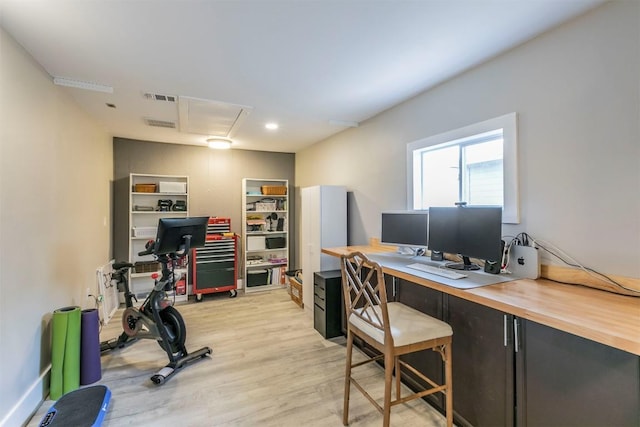 office featuring attic access, light wood-style flooring, and visible vents