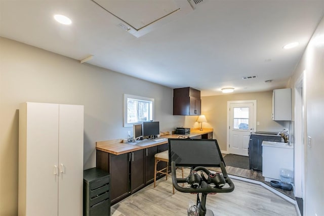 office space featuring light wood finished floors, visible vents, and recessed lighting