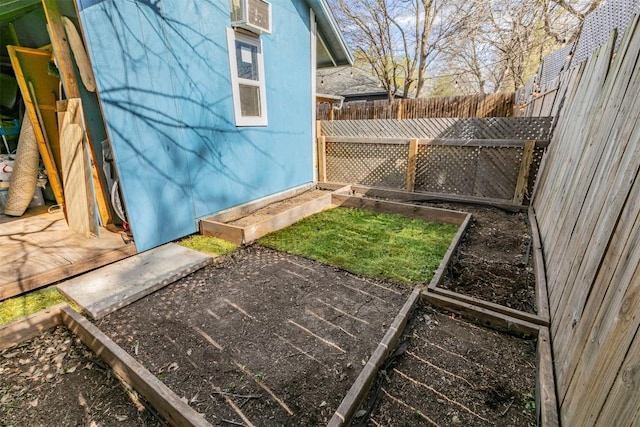 exterior space featuring a vegetable garden and fence