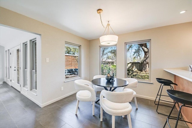 dining space featuring baseboards