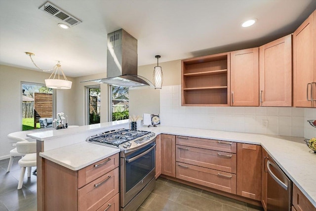 kitchen with visible vents, a peninsula, decorative backsplash, appliances with stainless steel finishes, and island range hood