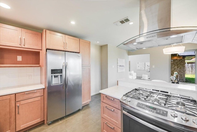 kitchen featuring visible vents, stainless steel appliances, light countertops, tasteful backsplash, and island range hood