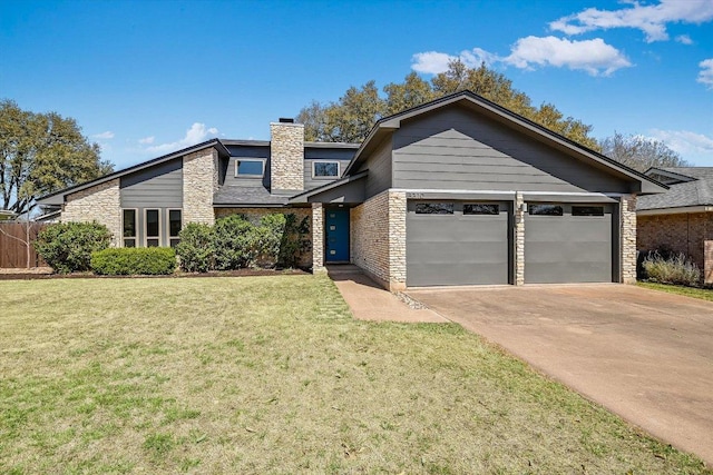 mid-century inspired home featuring a front yard, a garage, driveway, and a chimney