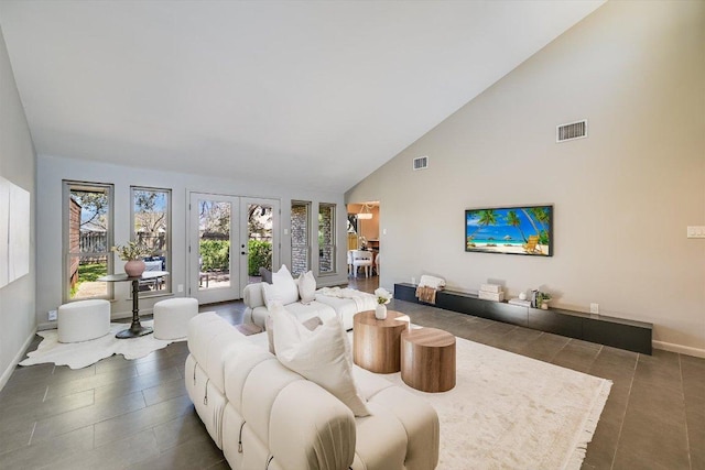 living room with baseboards, french doors, visible vents, and high vaulted ceiling