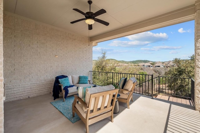 balcony featuring an outdoor living space and a ceiling fan