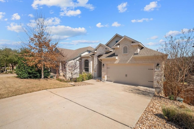 view of front of home with stone siding, a shingled roof, concrete driveway, a front yard, and an attached garage