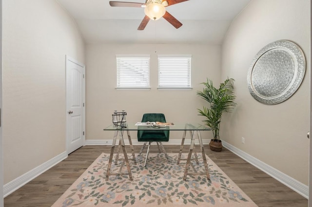 home office featuring baseboards, wood finished floors, ceiling fan, and vaulted ceiling