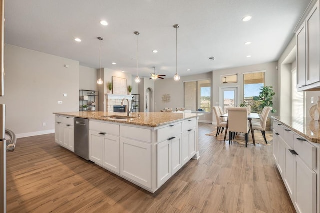 kitchen with recessed lighting, light wood-type flooring, and a sink