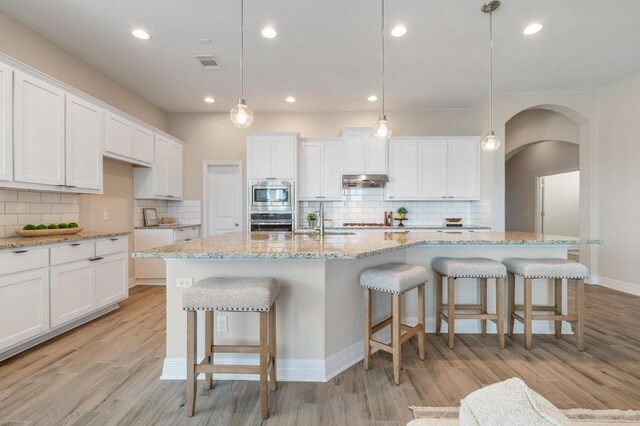 kitchen featuring white cabinetry, light wood-style flooring, visible vents, and appliances with stainless steel finishes