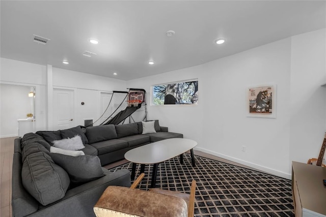 living room with visible vents, wood finished floors, recessed lighting, and baseboards