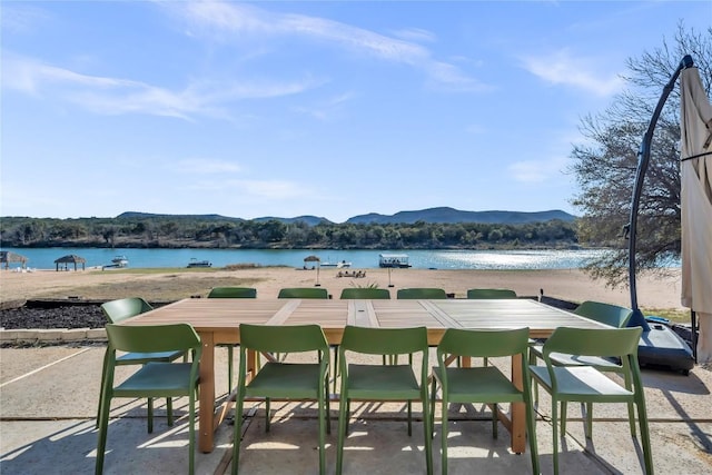 view of patio featuring a water and mountain view