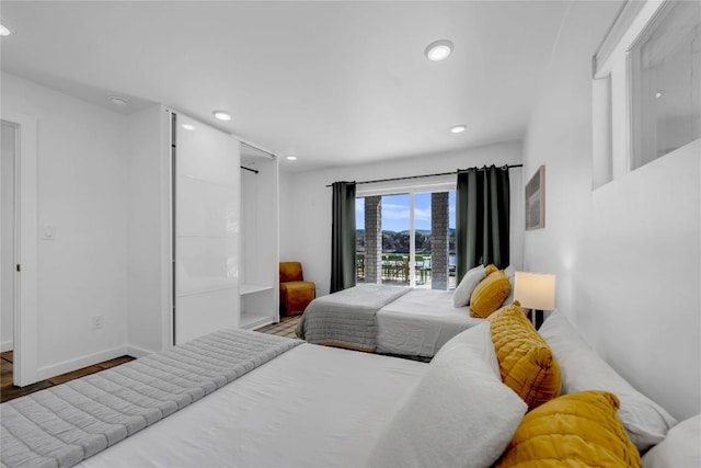 bedroom featuring recessed lighting, wood finished floors, and baseboards