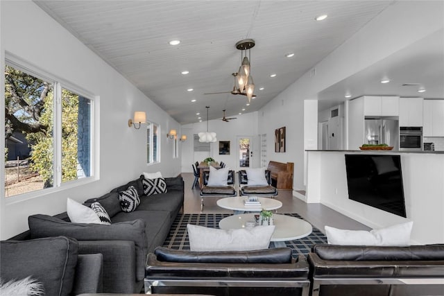 living room featuring vaulted ceiling, recessed lighting, and wood finished floors