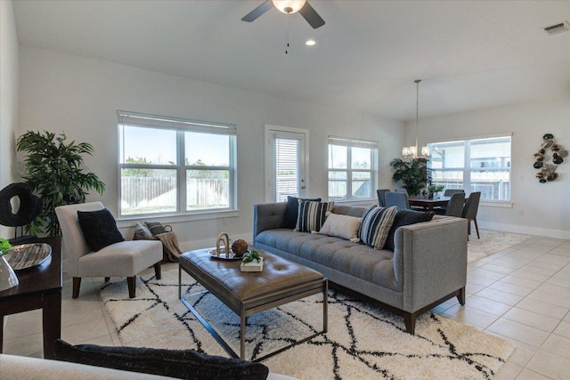 living area featuring visible vents, baseboards, light tile patterned floors, ceiling fan with notable chandelier, and recessed lighting