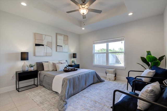 bedroom with light tile patterned floors, a ceiling fan, baseboards, recessed lighting, and a raised ceiling