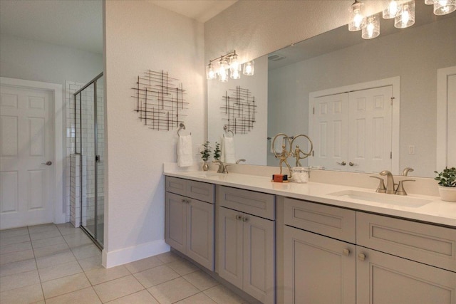 full bath with tile patterned floors, a stall shower, a sink, double vanity, and a chandelier