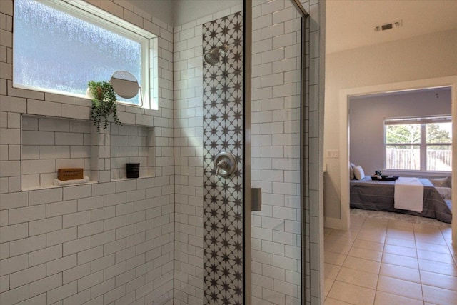 ensuite bathroom with tile patterned floors, visible vents, a shower stall, and ensuite bath