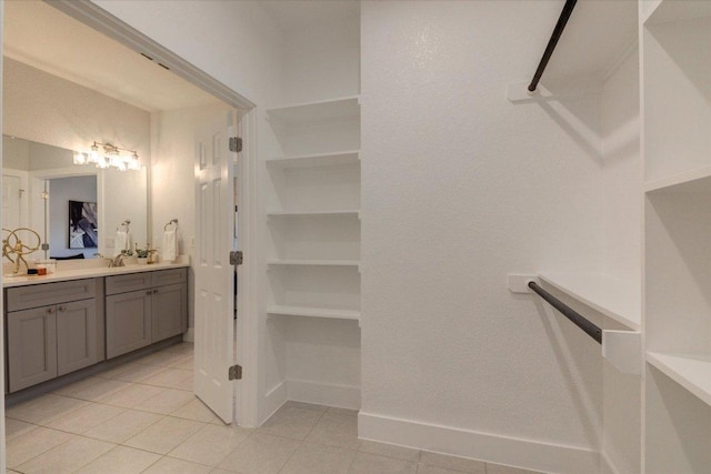 bathroom featuring tile patterned floors, baseboards, and vanity