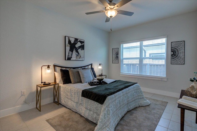 bedroom featuring light tile patterned floors, baseboards, and ceiling fan