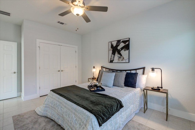 tiled bedroom featuring visible vents, baseboards, and a closet