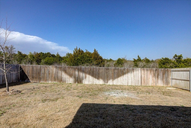 view of yard with a fenced backyard