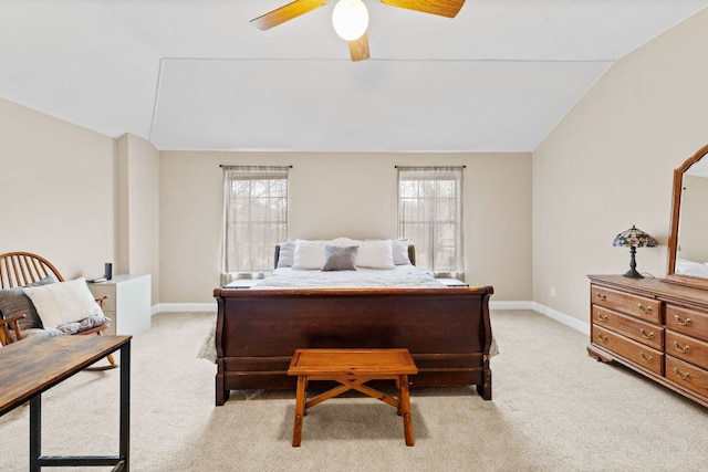 bedroom featuring light colored carpet, baseboards, lofted ceiling, and ceiling fan