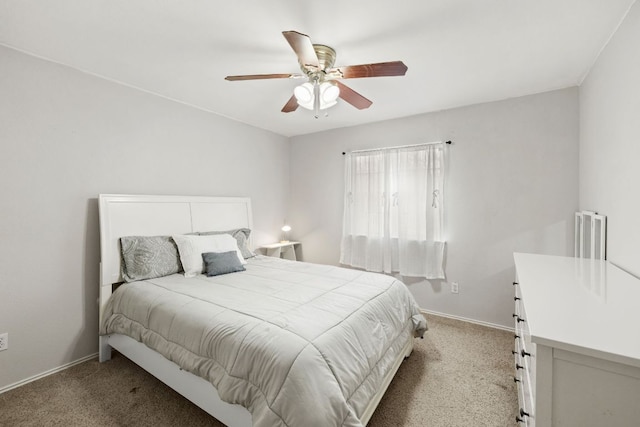 bedroom with light carpet, a ceiling fan, and baseboards