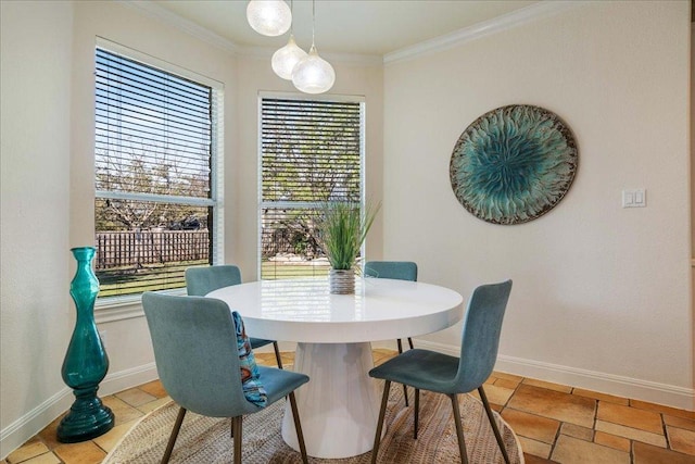 dining area with stone tile floors, baseboards, and ornamental molding