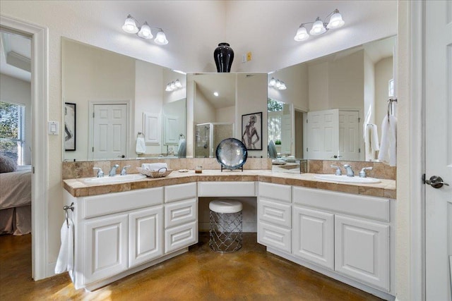 ensuite bathroom with a sink, a stall shower, ensuite bath, and double vanity