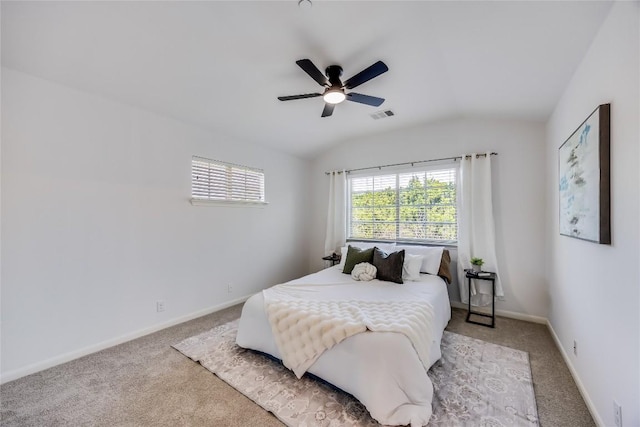 bedroom featuring vaulted ceiling, light colored carpet, visible vents, and baseboards