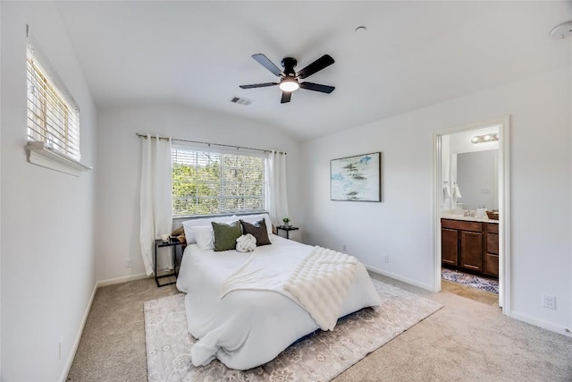 bedroom featuring baseboards, light carpet, and vaulted ceiling