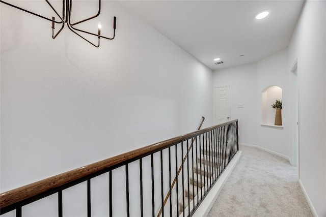 corridor featuring baseboards, a chandelier, light colored carpet, an upstairs landing, and recessed lighting