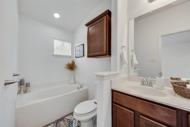 full bathroom with vanity, a garden tub, and toilet