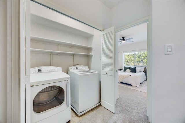 washroom with a ceiling fan, light carpet, separate washer and dryer, and laundry area