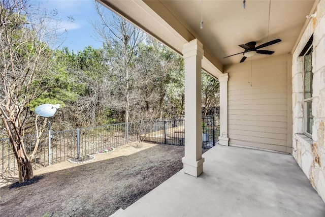 view of patio with a ceiling fan and fence