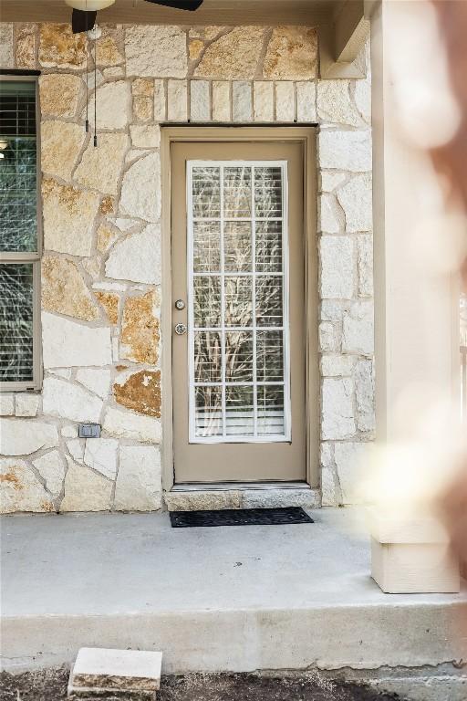 property entrance with stone siding