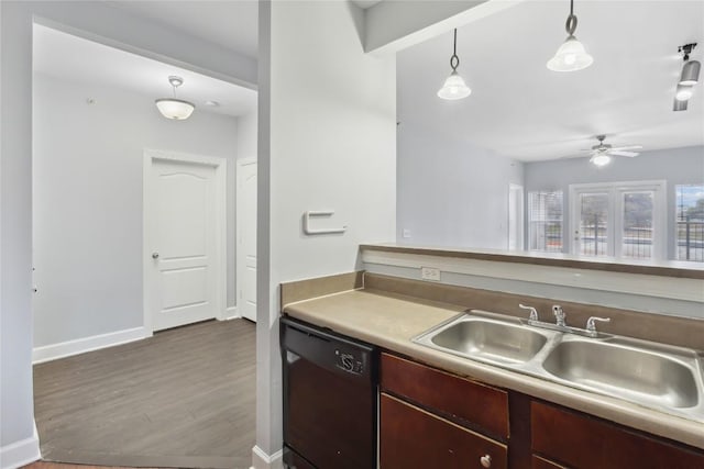 kitchen with a ceiling fan, baseboards, dark wood finished floors, a sink, and black dishwasher