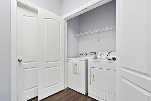 clothes washing area with laundry area, dark wood-style floors, and washing machine and dryer