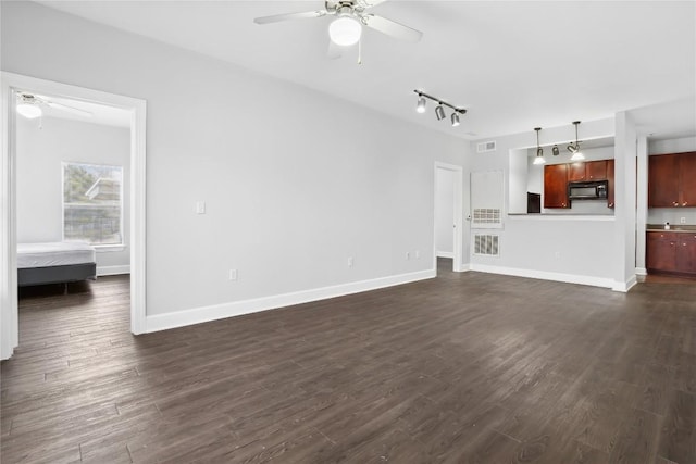 unfurnished living room with baseboards, dark wood-style flooring, and ceiling fan