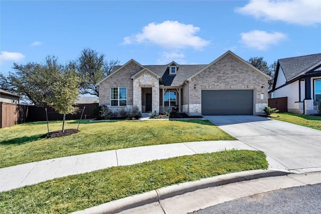 view of front facade featuring fence, a front yard, a garage, stone siding, and driveway