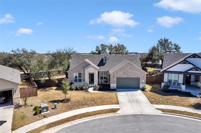 view of front facade with driveway, stone siding, fence, a shingled roof, and a garage