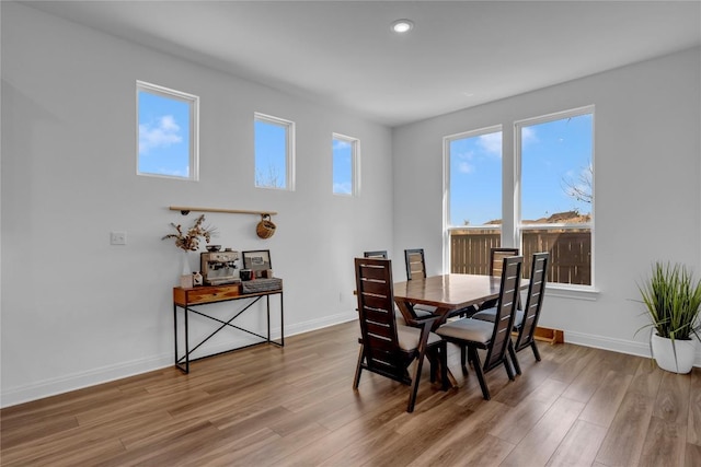 dining area with recessed lighting, baseboards, and wood finished floors