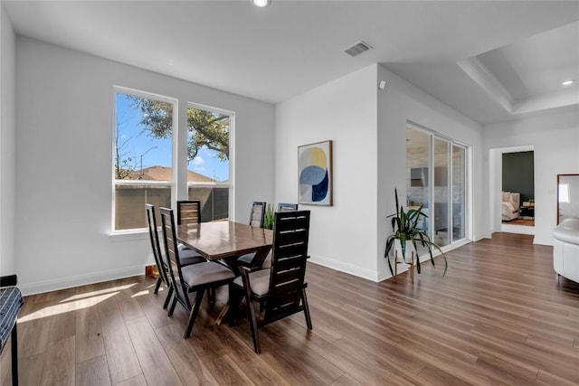 dining space with recessed lighting, visible vents, baseboards, and wood finished floors