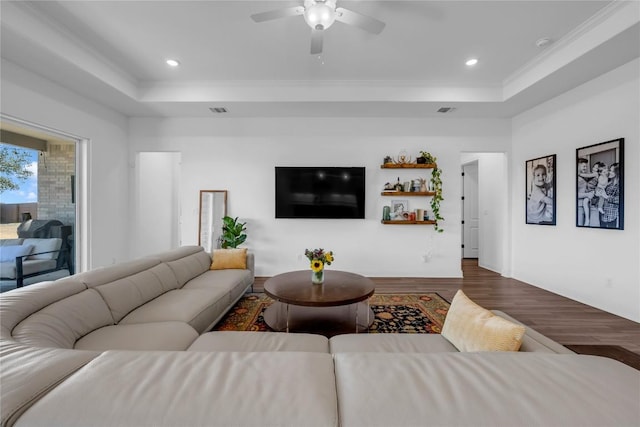 living room featuring recessed lighting, a raised ceiling, ceiling fan, and dark wood-style flooring