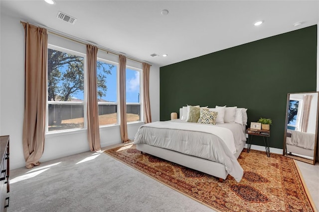 carpeted bedroom with recessed lighting, visible vents, and multiple windows