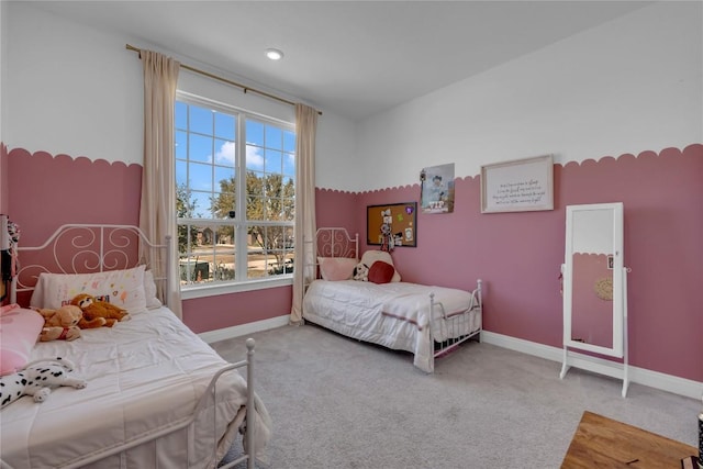 carpeted bedroom featuring baseboards